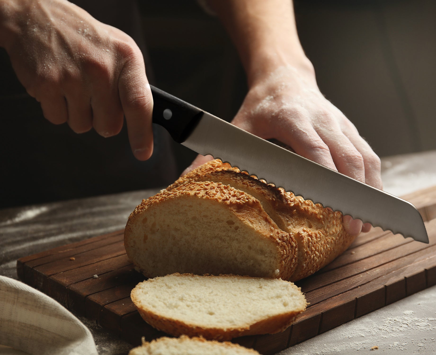 A bread knife slicing through bread