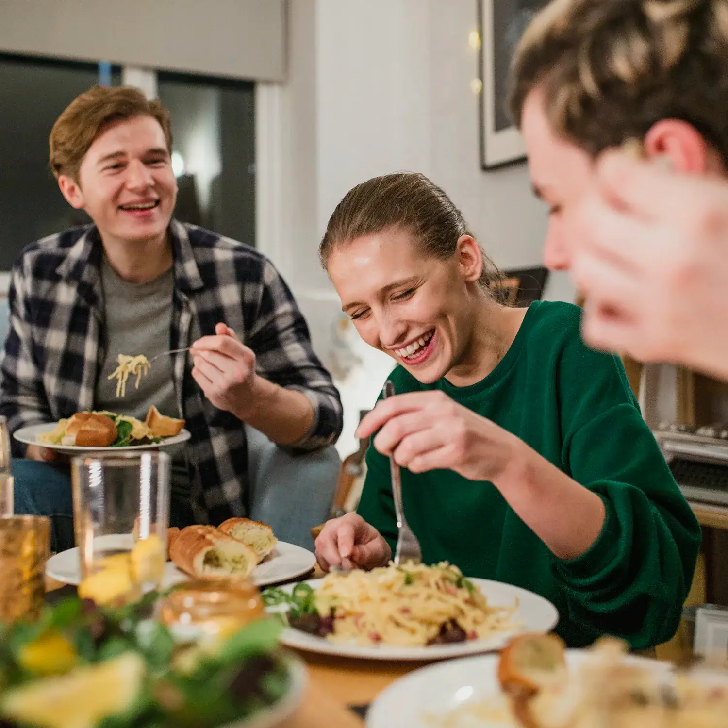 Family smiling and eating dinner