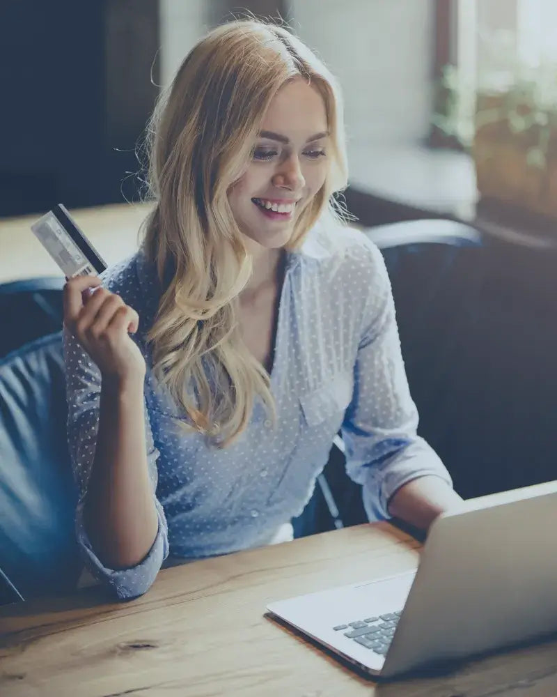 Woman using a credit card to pay online