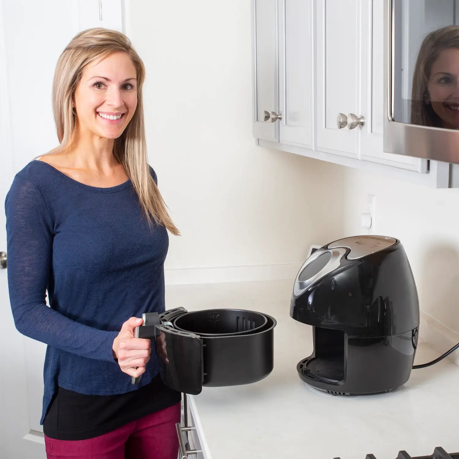 Woman posing with air fryer container
