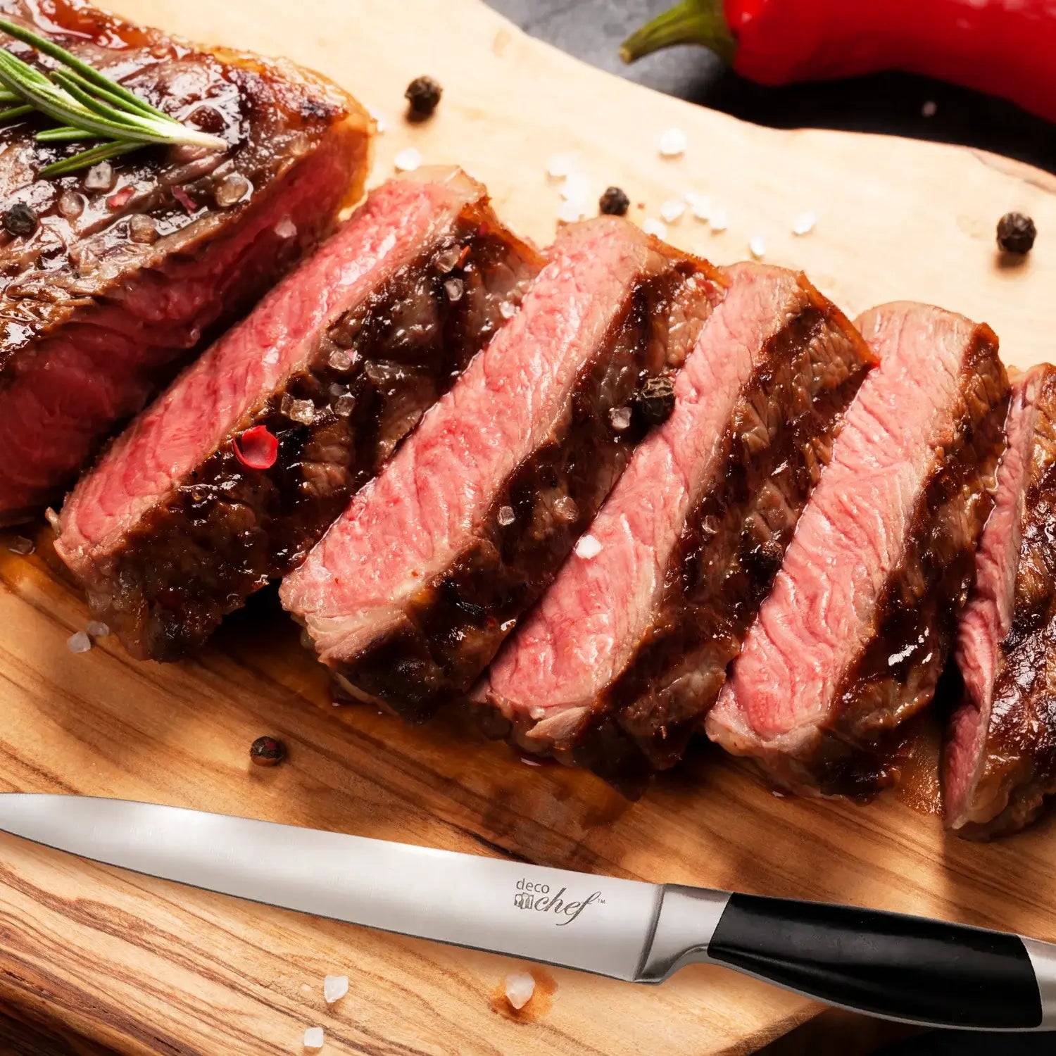 Deco Chef slicing knife on a cutting board with sliced steak