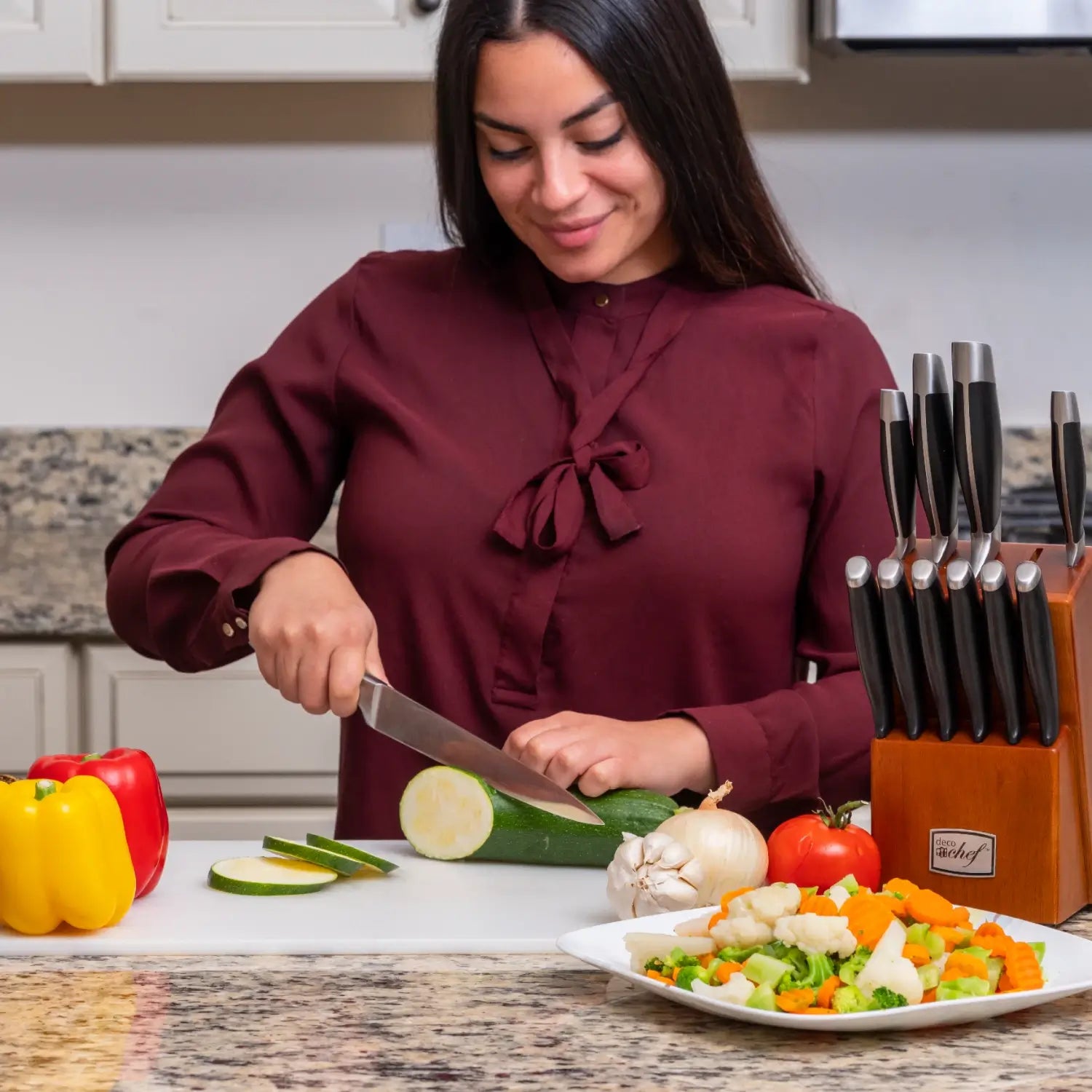 Woman cutting through vegetables
